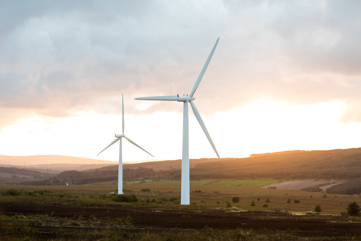 2 wind turbines sunset