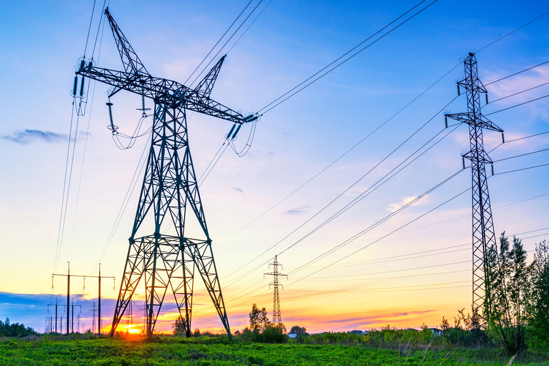 High-voltage transmission lines at sunset